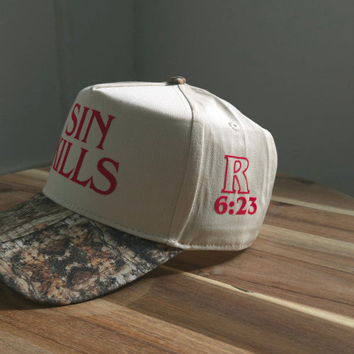 White cap with red text on a wooden surface